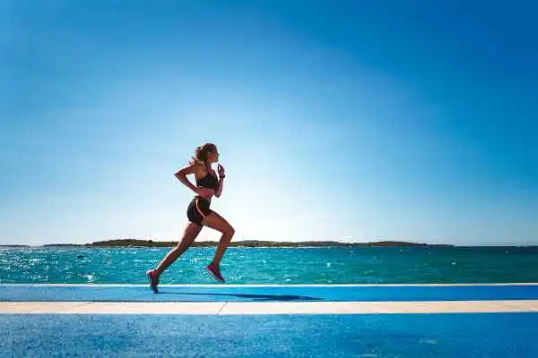 Woman running showing strong leg muscle Birkdale